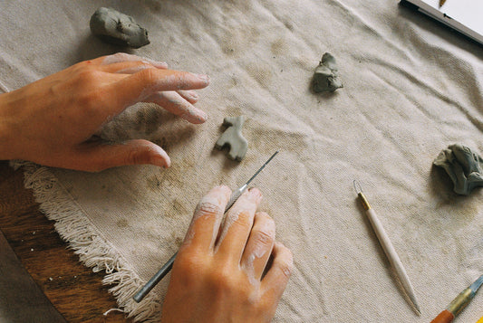 hands making pottery horse jewelry pendant stoneware