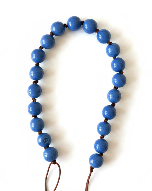Blue beaded necklace on a white background